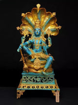 Four-armed Lord Vishnu brass idol, blue skin, seated on Sheshnag pedestal, 28 in