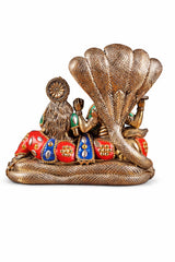 Brass deity idol rear view with large cobra hood, jeweled red, blue, and green seats