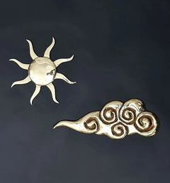 Brass wall hanging sunburst emblem and ornate scroll detail