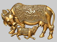 Ornate brass calf sculpture close-up with engraved patterns on body and legs