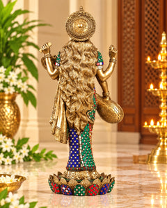 Back view of standing Saraswati brass statue with long hair, green and blue robe trim