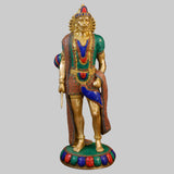 Standing Hanuman brass statue with colorful painted drape and jeweled crown, gold finish.