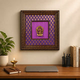 Ganesha brass wall hanging in wooden frame, purple patterned backing