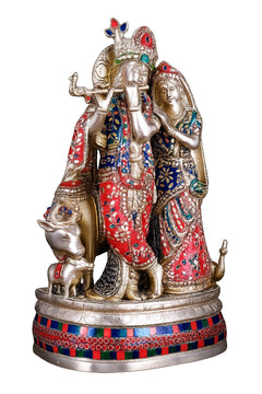Brass Radha Krishna statue with cow and calf, red sari, blue jewelry, raised hands