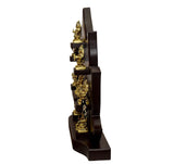 Side view of brass Ashtalakshmi idol set with gold statues on dark wooden frame