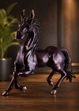 Antique brown brass galloping horse statue, side view with raised head and flowing mane