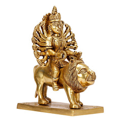 Side view of brass Durga idol seated on lion, multi-armed pose on square base