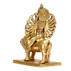 Back view of brass Durga idol on lion, detailed halo fan and ornaments on base