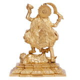 Gold-toned Kali idol statue from behind, flowing hair and skirt details on base