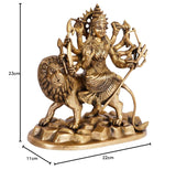 Brass Durga idol on lion, height 23cm, base 22cm wide; four arms holding weapons