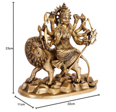 Brass Durga idol on lion, height 23cm, base 22cm wide; four arms holding weapons