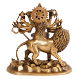 Brass Durga idol back view on lion, circular spiked halo and arm-held accessories
