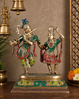 AONA brass Radha-Krishna dancing sculpture with painted green, red, and gold details