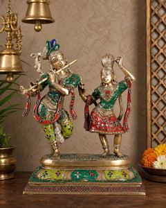 AONA brass Radha-Krishna dancing sculpture with painted green, red, and gold details