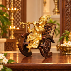 Brass Krishna idol on rocking chair, flute-playing pose, gold-toned carved chair