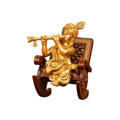 Brass Krishna idol figurine on rocking chair, front view, flute and crown details