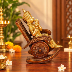 Brass Krishna idol figurine on rocking chair with flute, side view, decorative carving