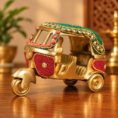 Decorative brass auto rickshaw with green roof, red bead inlay, four small wheels