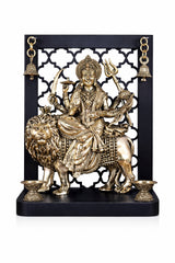 Brass Durga goddess on temple arch with hanging bells, seated on lion
