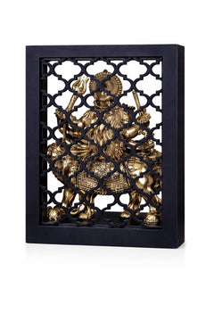 Brass Durga goddess relief inside temple arch with patterned lattice frame