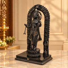 Lord Ram standing brass idol with golden-and-black patina, side view on pedestal.