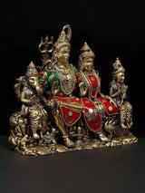 Brass Shiva family idol, central deity holding trident, two side figures, red accents