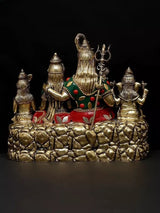 Brass Lord Shiva family idol from side, trident and attendants on stepped base, red details