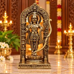 Brass deity statue with ornate arched frame, standing on decorated base