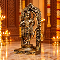 Brass deity statue standing in arched frame, bow raised, detailed jewelry and base