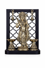Brass Lord Rama idol with dual diyas and two hanging bell accents, gold tone