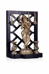 Brass Lord Krishna idol with hanging bells, dual lamp holders on stand