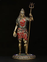 Standing Shiva brass idol with trident, red-and-green jeweled clothing, 12 in