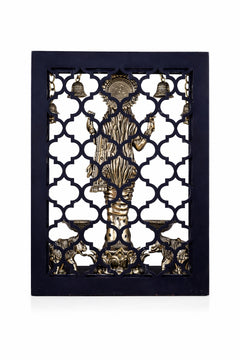 Brass Lakshmi idol reverse view with hanging bells and diya elephants, ornate frame