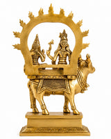 Brass Nandi figure carrying seated Shiv and Parvati under arched halo; decorative base