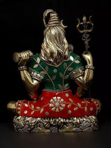 Back view of brass Lord Shiva statue, long hair and green patterned upper cloth