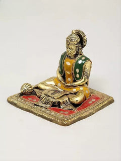 Small brass Hanumanji murti with detailed ornaments, green vest, seated on red base