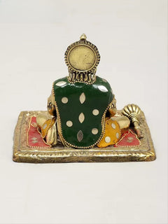 Small brass Hanumanji murti back view, green dotted vest, circular head ornament