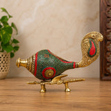 Decorative brass conch on stand with green-red stonework, gold detailing, 9 in.