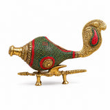 Decorative brass conch on stand, green-red mosaic pattern with gold ornamental handle.