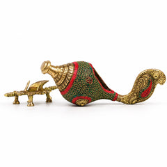 Decorative brass conch on stand, green-red patterned body with carved gold tail.