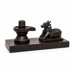 Small dark Shiva lingam and seated Nandi statue set on rectangular base, front view