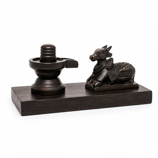 Small dark Shiva lingam and seated Nandi statue set on rectangular base, front view