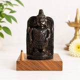 Dark bronze Lord Venkateswara statue on wooden base, with incense cone