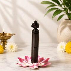 Natural ebony wood shivling stand with carved finial, set on pink lotus flower
