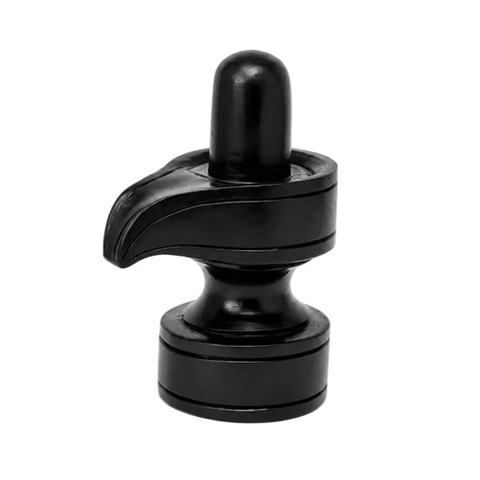 Black shivling idol with tall rounded top and curved leaf-like base on pedestal