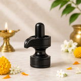 Ebony wood shivling idol with curved top and round base, dark black finish