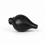 Dark wooden puja conch with carved swirls and pebbled ridged surface