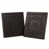 Pair of dark yantra boards with number panels on the left and symbol chart on right