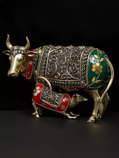 Brass cow and calf figurine with raised filigree, green side panels and red saddle