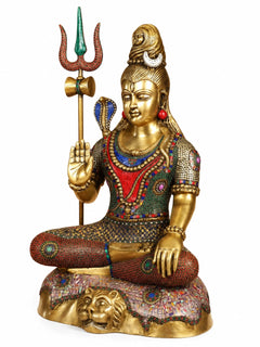Brass Lord Shiva statue seated, blessing hand raised with trident; jeweled multicolor robe
